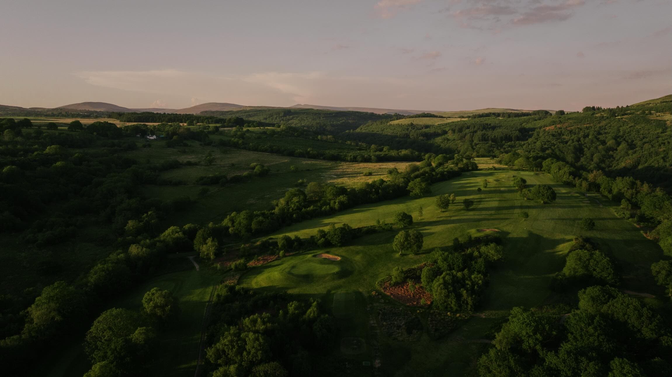 Glynneath Golf Club from the air: fairways through woodland at the top of the Neath valley